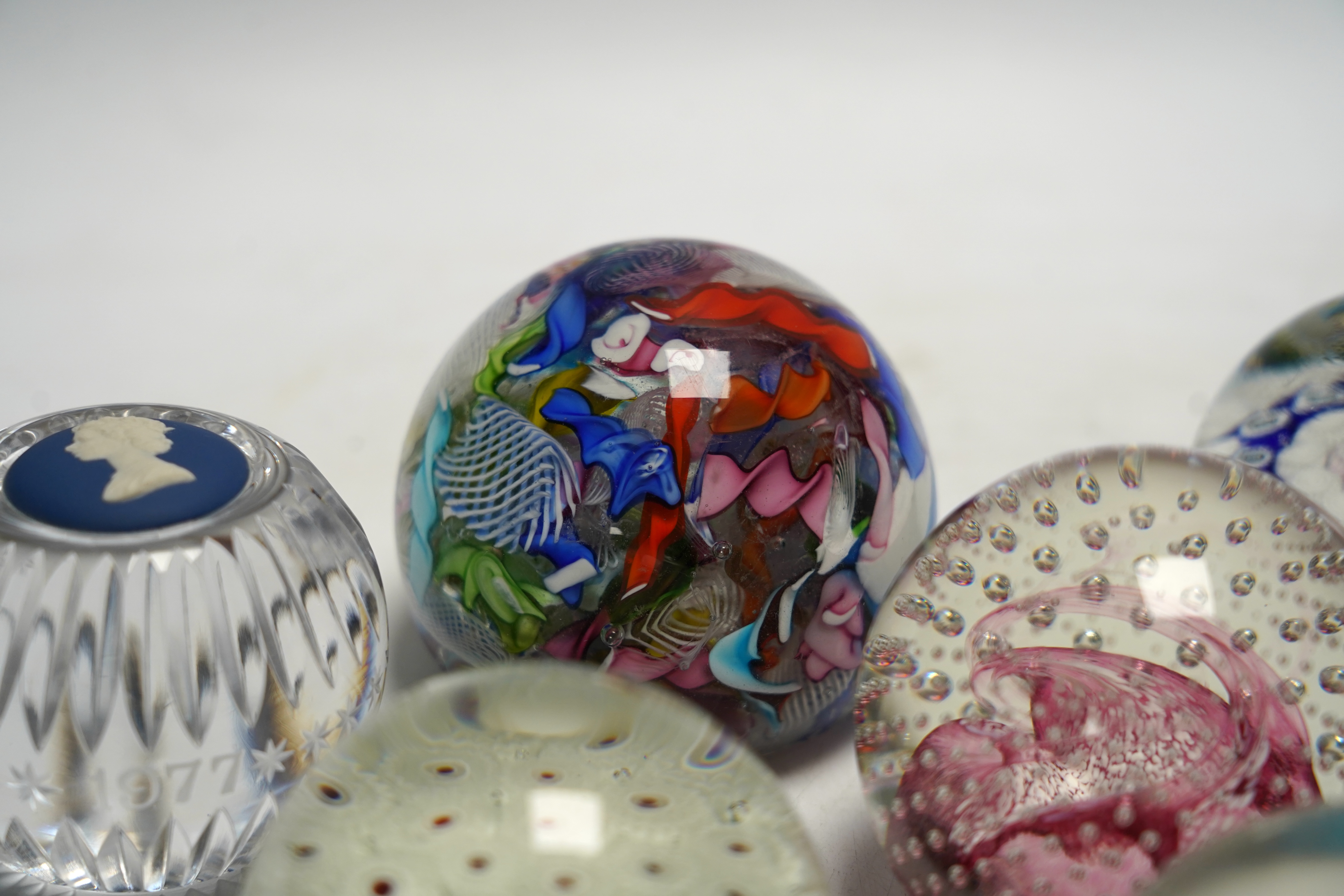 Eleven mixed Scottish and other glass paperweights including Caithness, largest 8.5cm in diameter